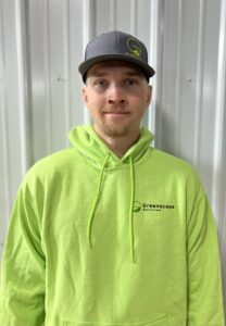 Smiling employee wearing a Greenscape hoodie